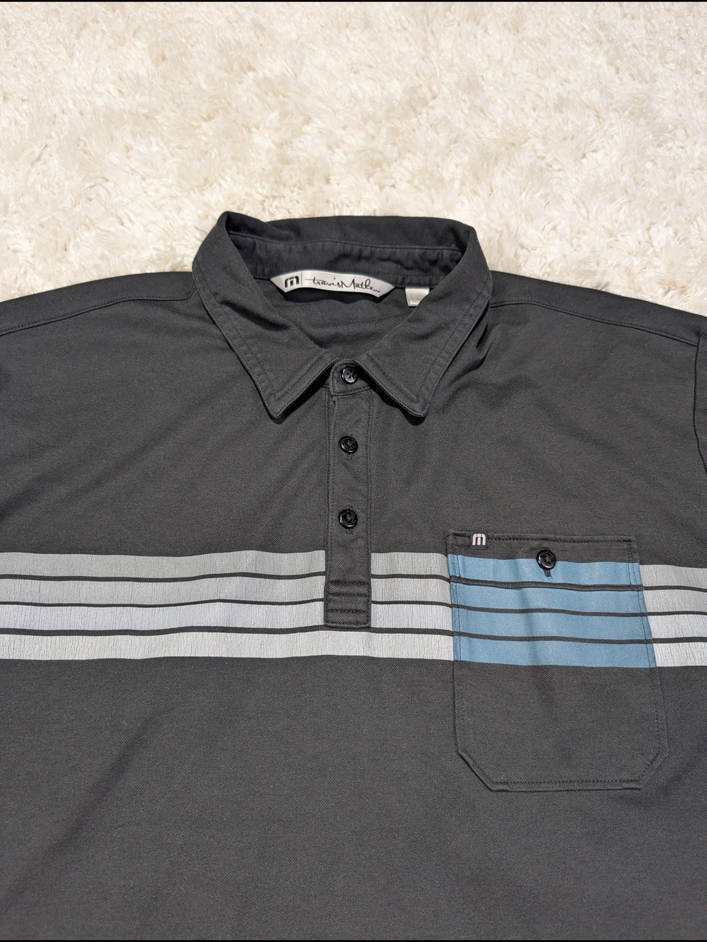Travis Mathew Black Short Sleeve Polo with Blue & Gray Chest Stripes